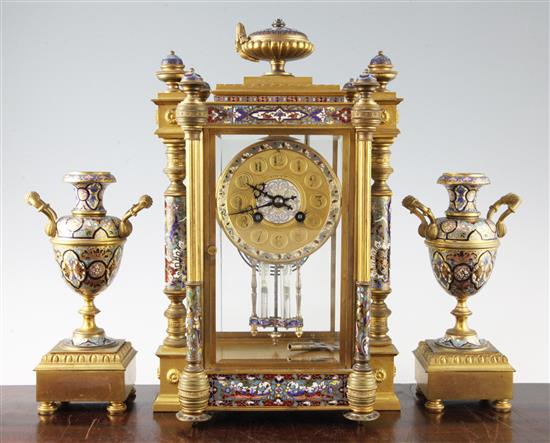 An early 20th century French ormolu and champleve enamel clock garniture, clock 14.5in.